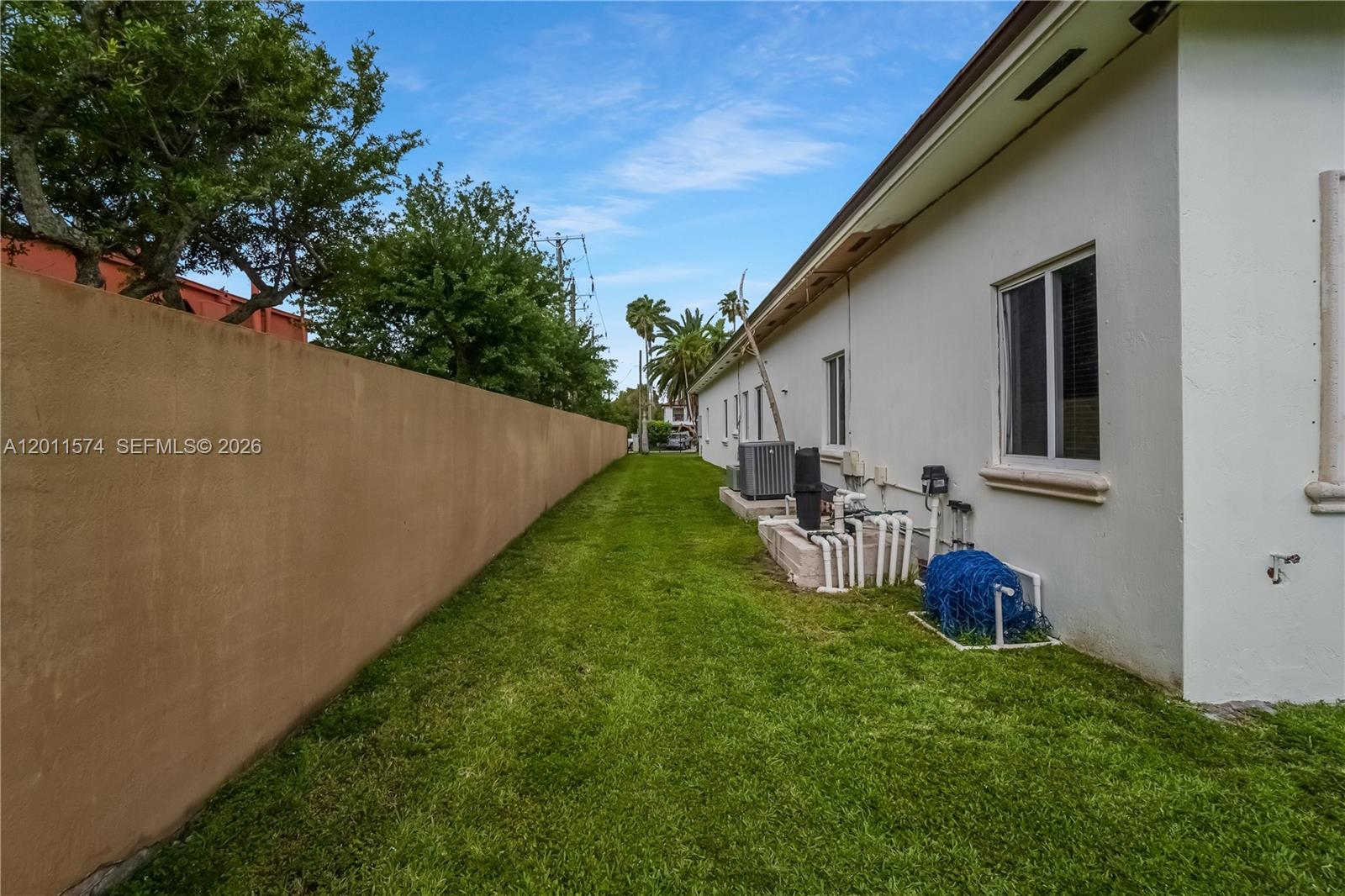 4025 Southwest 128th Avenue Miami, FL 33175 - Photo 67 of 93 a view of a backyard with table and chairs potted plants and a palm tree