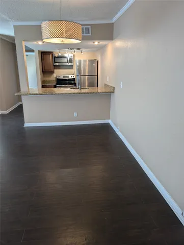 a view of a kitchen with a sink stove and microwave