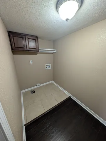 an empty room with wooden floor and window