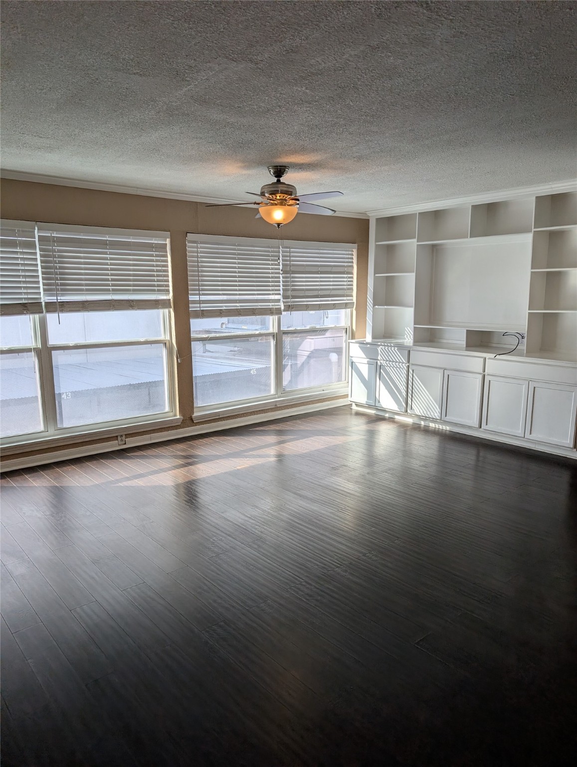 2503 McCue Road, Unit 37 Houston, TX 77056 - Photo 5 of 18 a view of an empty room with wooden floor and a window