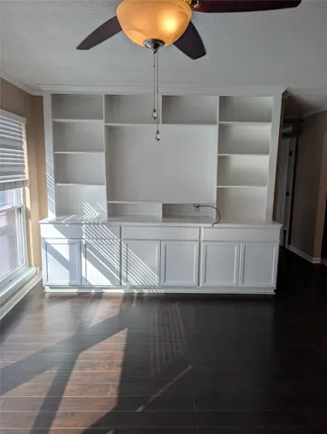 a view of a living room and hallway with wooden floor