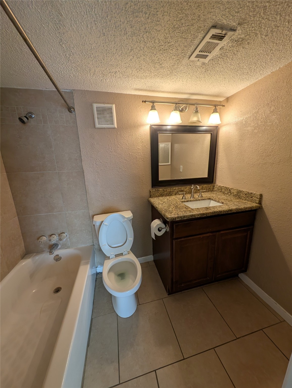 2503 McCue Road, Unit 37 Houston, TX 77056 - Photo 8 of 18 a bathroom with a granite countertop toilet a sink and bathtub