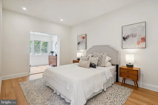 a bedroom with a bed and a painting on the wall