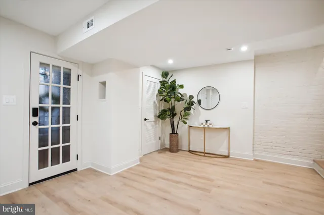 a very nice looking room with a large window and wooden floor