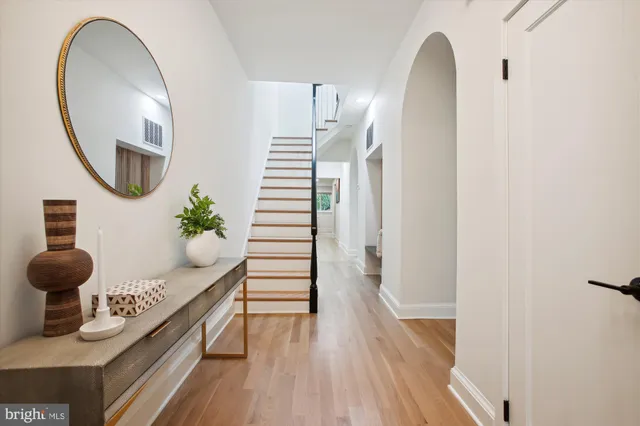 a room with wooden floor and potted plant