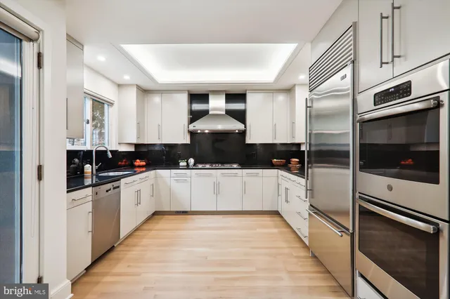 a kitchen with stainless steel appliances granite countertop a stove and a refrigerator