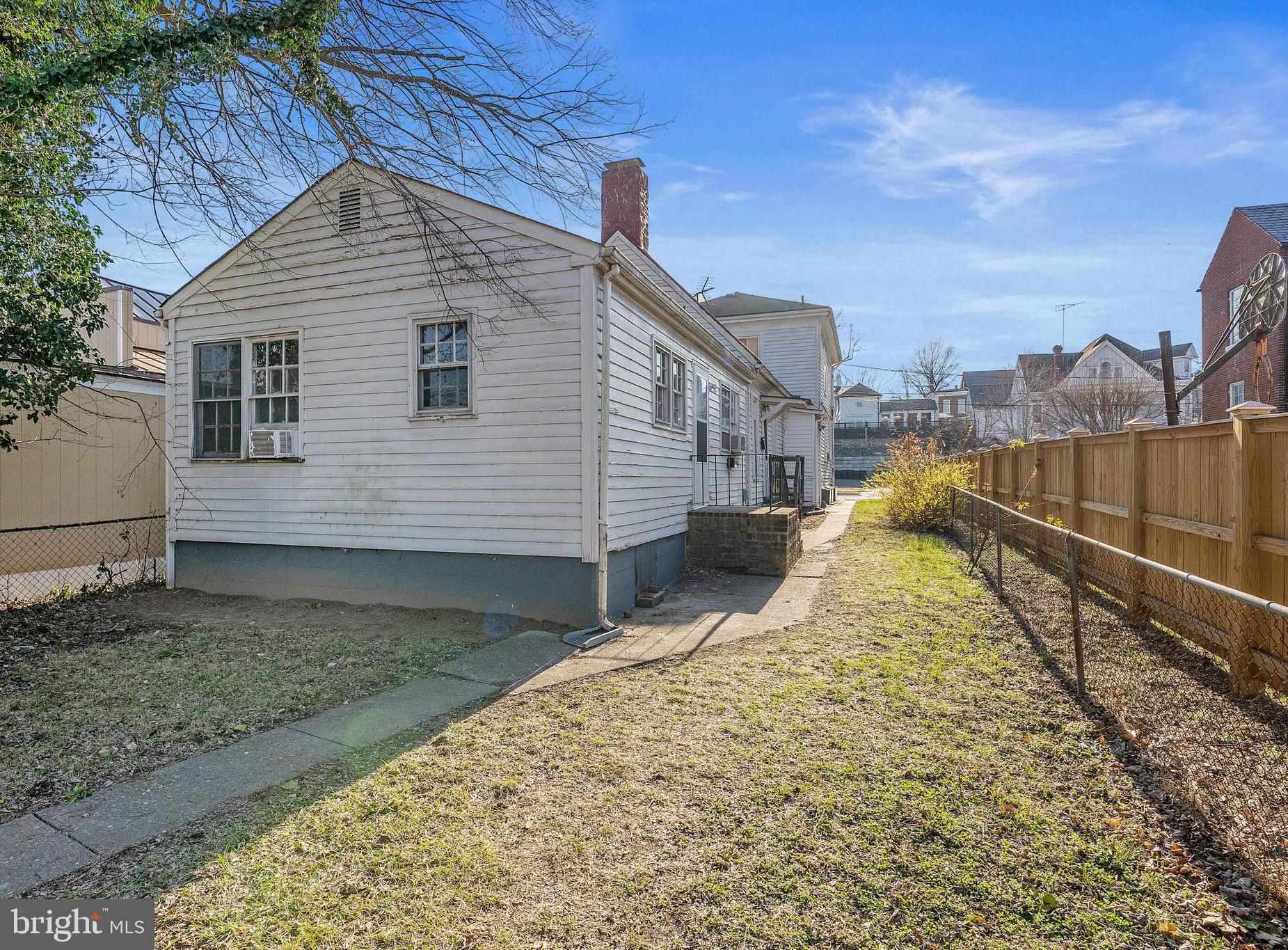 1117 Caroline Street, Unit E Fredericksburg, VA 22401 - Photo 1 of 17 a view of a house with a yard