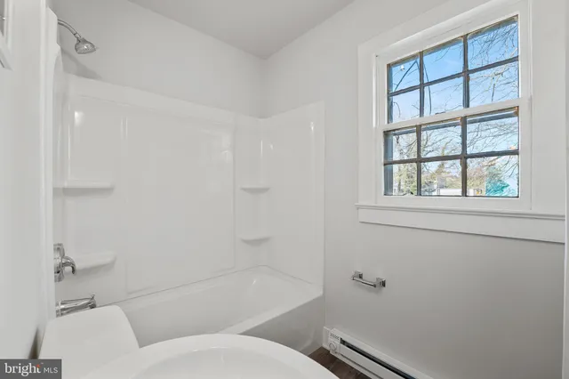a bathroom with a toilet and a bathtub