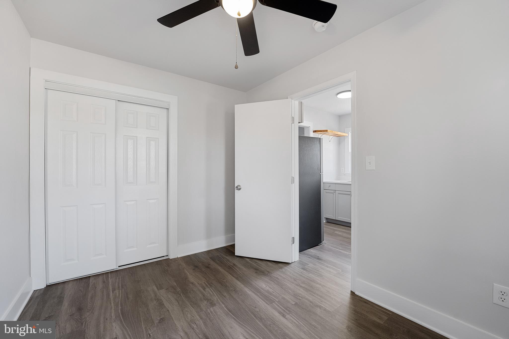 1117 Caroline Street, Unit E Fredericksburg, VA 22401 - Photo 14 of 17 an empty room with wooden floor and windows
