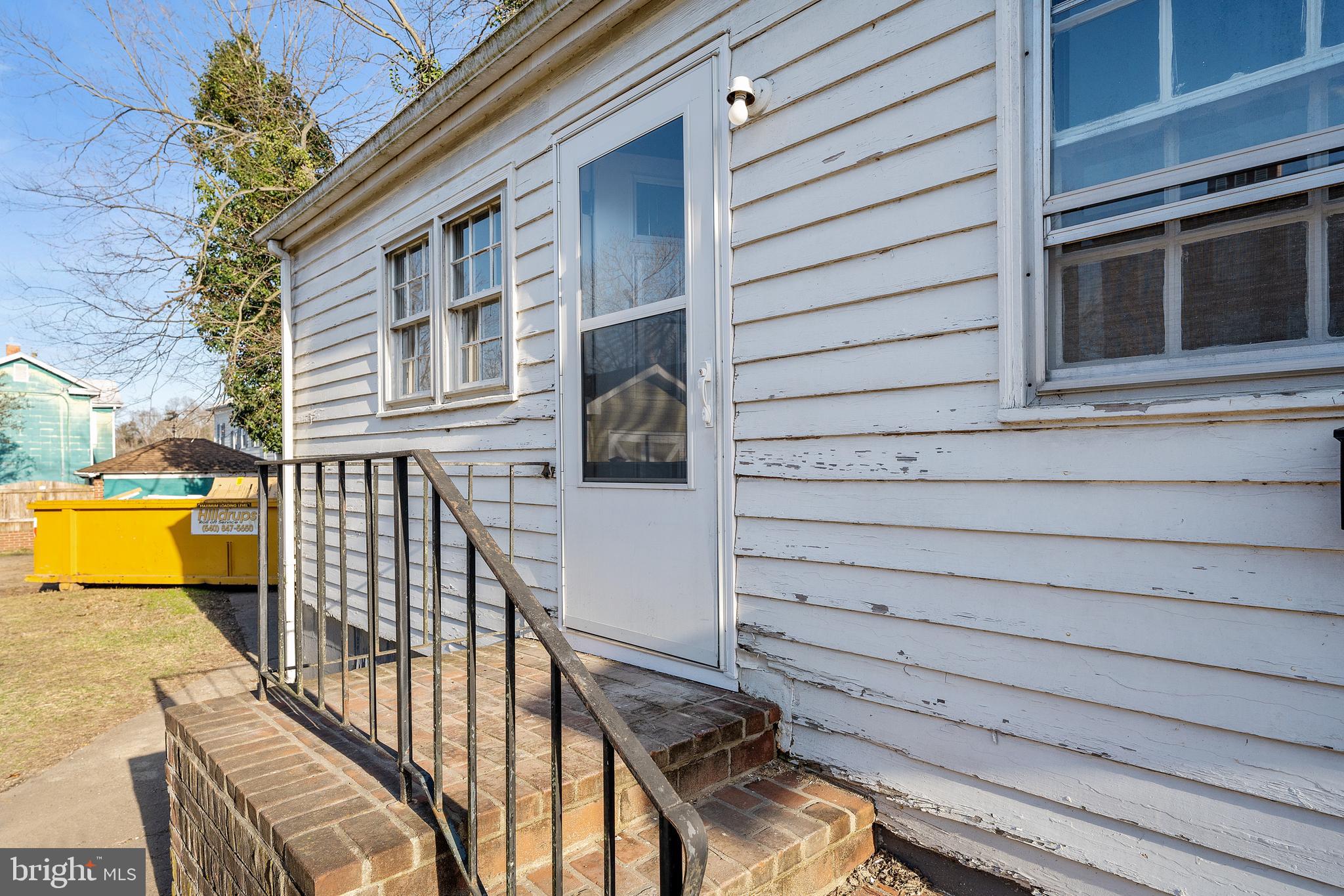 1117 Caroline Street, Unit E Fredericksburg, VA 22401 - Photo 2 of 17 a view of a balcony with two chairs and a barbeque