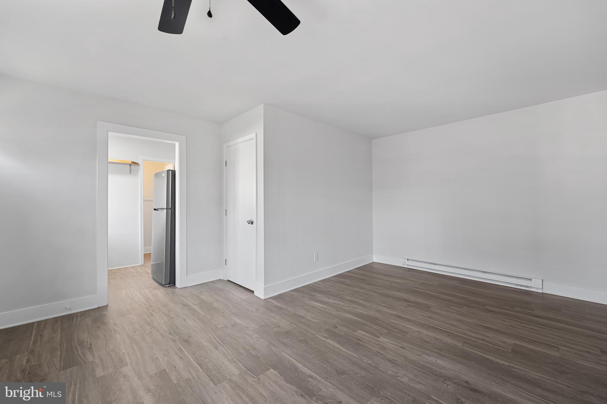 1117 Caroline Street, Unit E Fredericksburg, VA 22401 - Photo 4 of 17 a view of an empty room with wooden floor
