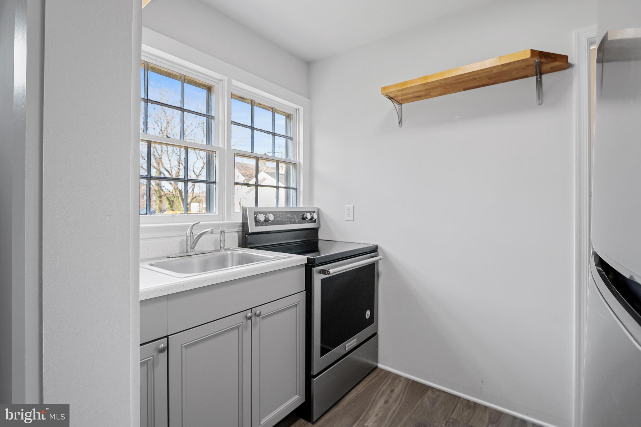 1117 Caroline Street, Unit E Fredericksburg, VA 22401 - Photo 7 of 17 a utility room with a sink dryer and washer