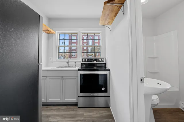 a kitchen with a stove and a shower