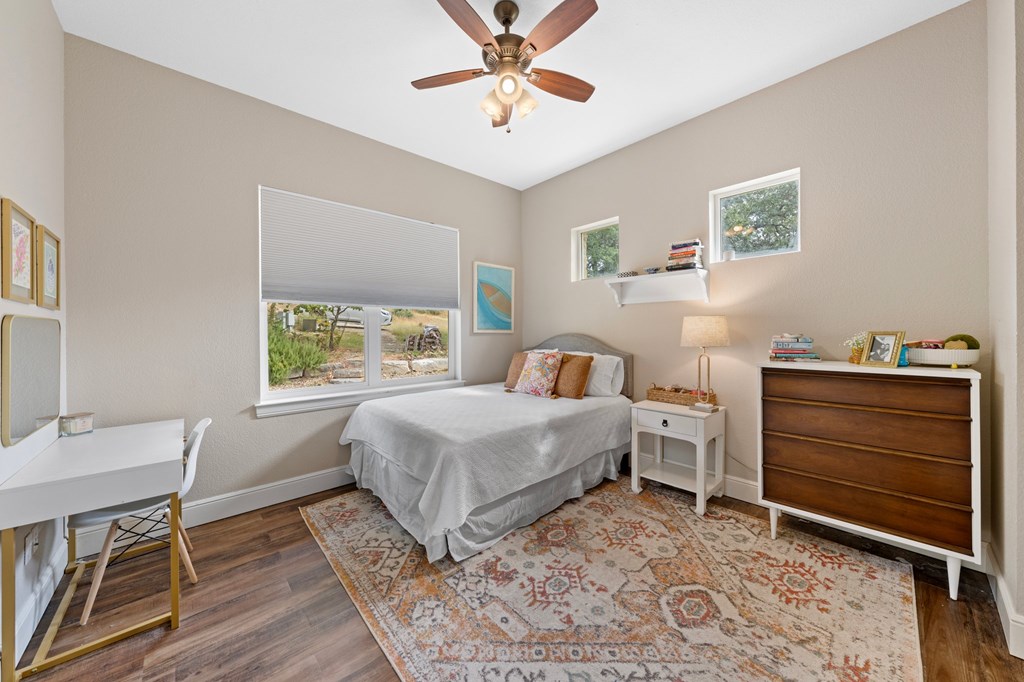 151 Kerr Canyon Pass South Kerrville, TX 78028 - Photo 15 of 45 a bedroom with a bed and a table in it