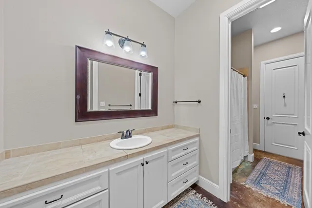 a bathroom with a sink a vanity and a mirror