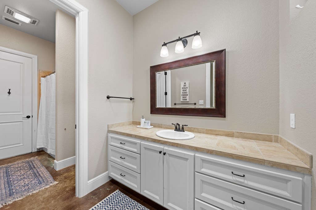 151 Kerr Canyon Pass South Kerrville, TX 78028 - Photo 17 of 45 a bathroom with a toilet sink and mirror