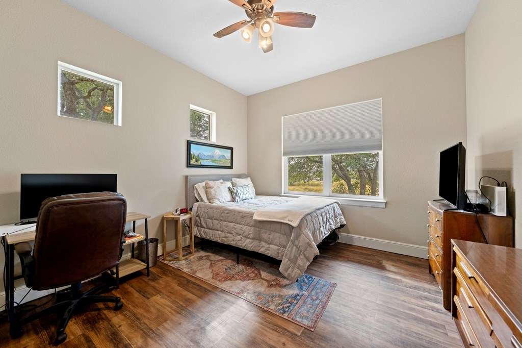 151 Kerr Canyon Pass South Kerrville, TX 78028 - Photo 18 of 45 a bedroom with a bed and a flat screen tv