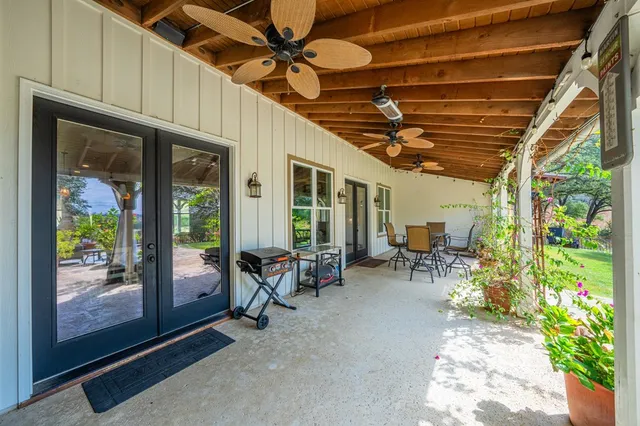 a view of a porch with furniture and a backyard