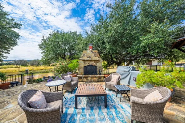 a view of a patio with couches table and chairs and potted plants