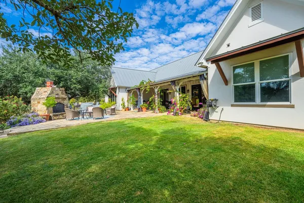 a view of a house with a yard porch and sitting area
