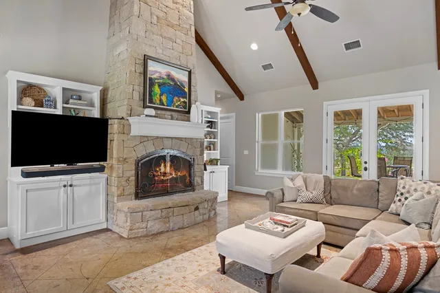 a living room with furniture a flat screen tv and a fireplace