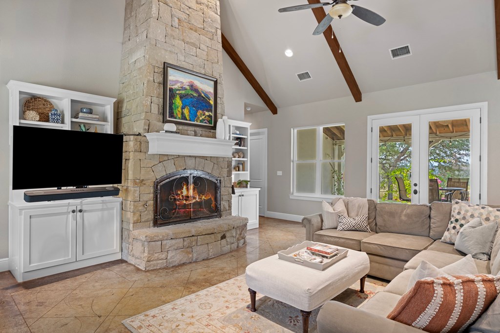 151 Kerr Canyon Pass South Kerrville, TX 78028 - Photo 4 of 45 a living room with furniture a flat screen tv and a fireplace