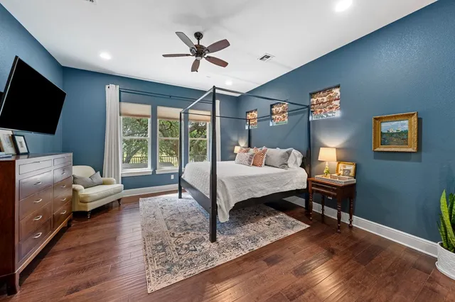 a bedroom with a bed window and a flat screen tv