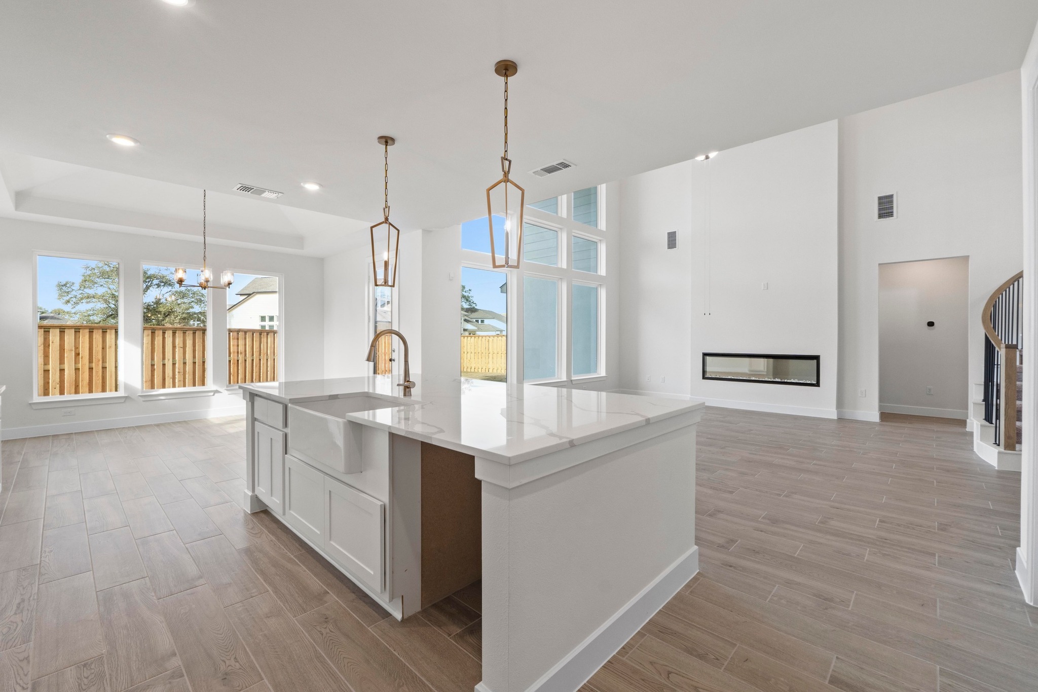 604 Lightstone Drive Georgetown, TX 78633 - Photo 7 of 39 a large kitchen with stainless steel appliances kitchen island granite countertop a refrigerator a oven a island and a wooden floor