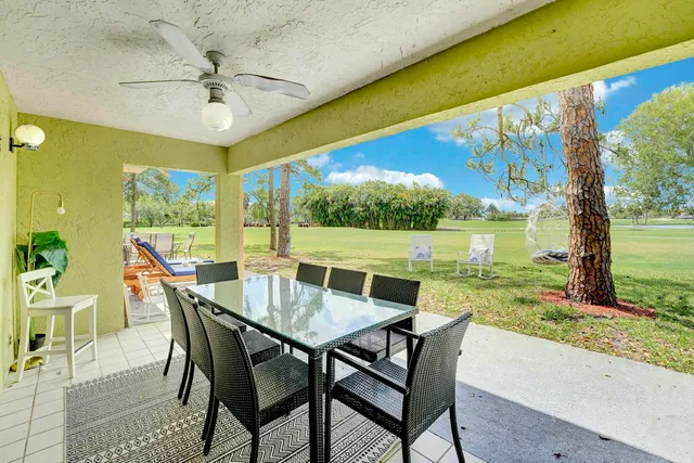 a view of an outdoor dining space with furniture and garden
