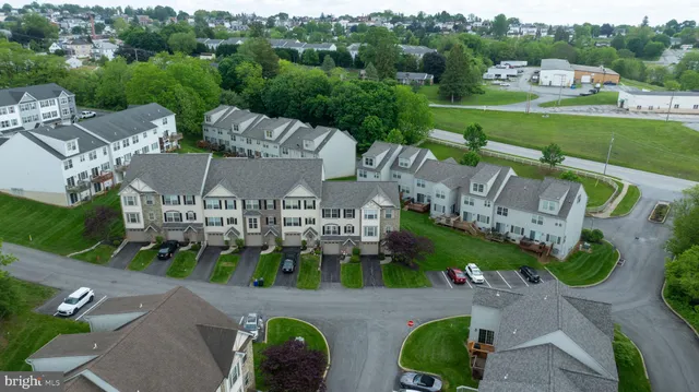 an aerial view of a house with a garden and outdoor seating