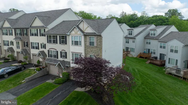 a aerial view of a house next to a yard