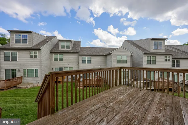 a view of a wooden deck and a yard