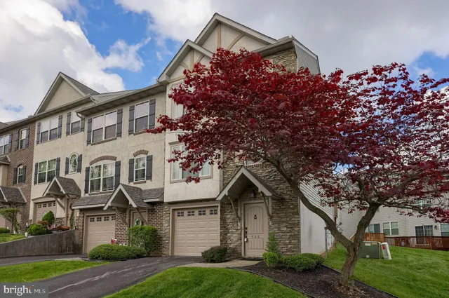 front view of a house with a tree