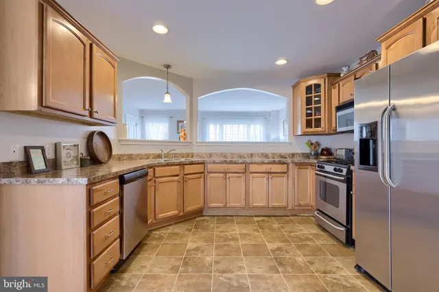 a kitchen with stainless steel appliances granite countertop a sink and cabinets