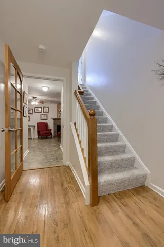 a view of entryway and hall with wooden floor