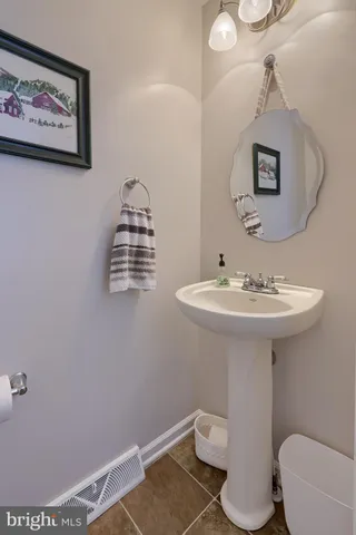 a bathroom with a sink mirror and toilet