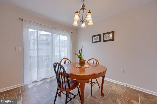 a dining room with furniture and chandelier