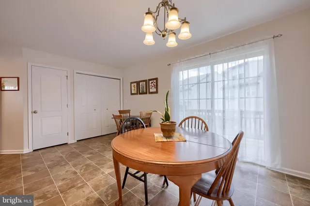 a view of a dining room with furniture and chandelier