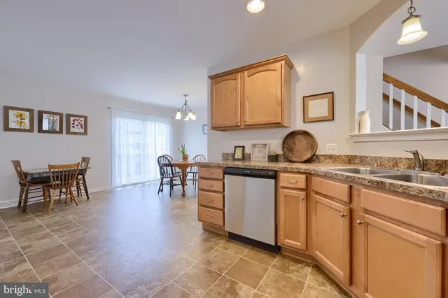a kitchen with furniture a stove a sink a window and dining table