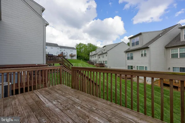 a balcony with wooden floor and fence