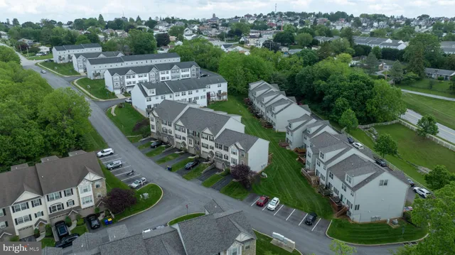 an aerial view of a house with garden space and street view