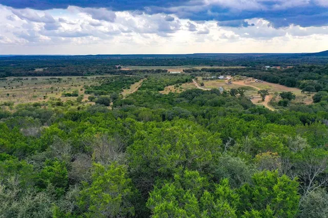 a view of a lake with houses in back