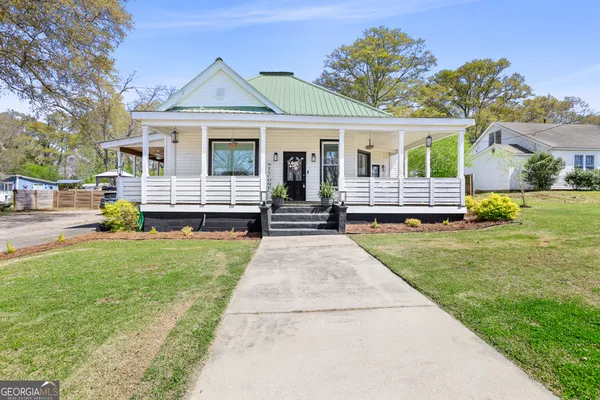 a front view of a house with a garden