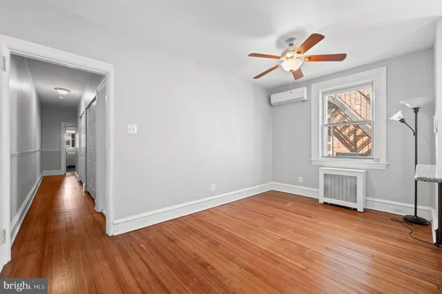 wooden floor in an empty room with a window