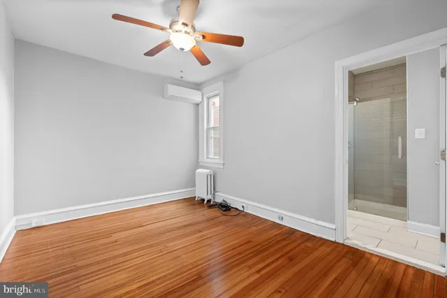 a view of room with wooden floor ceiling fan and window