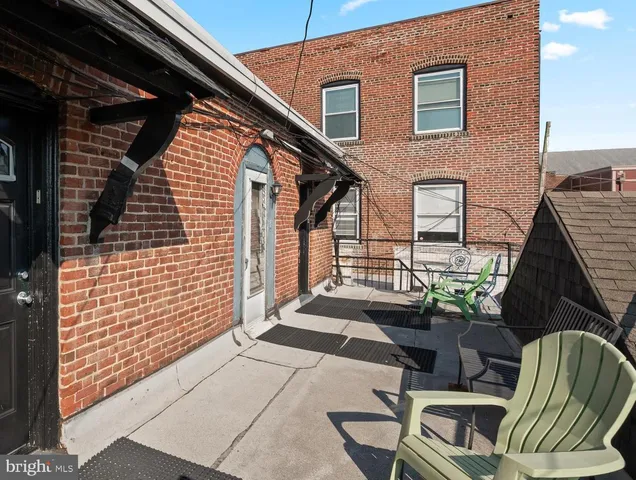 a balcony with furniture and a potted plant