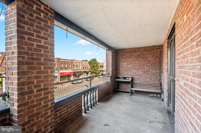a balcony with chairs and stove