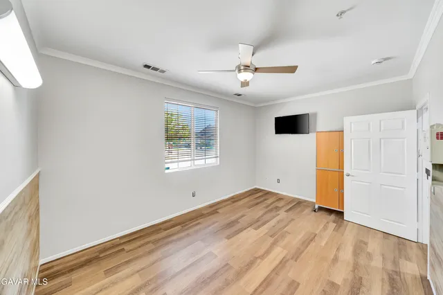 a view of a hallway with wooden floor and closet