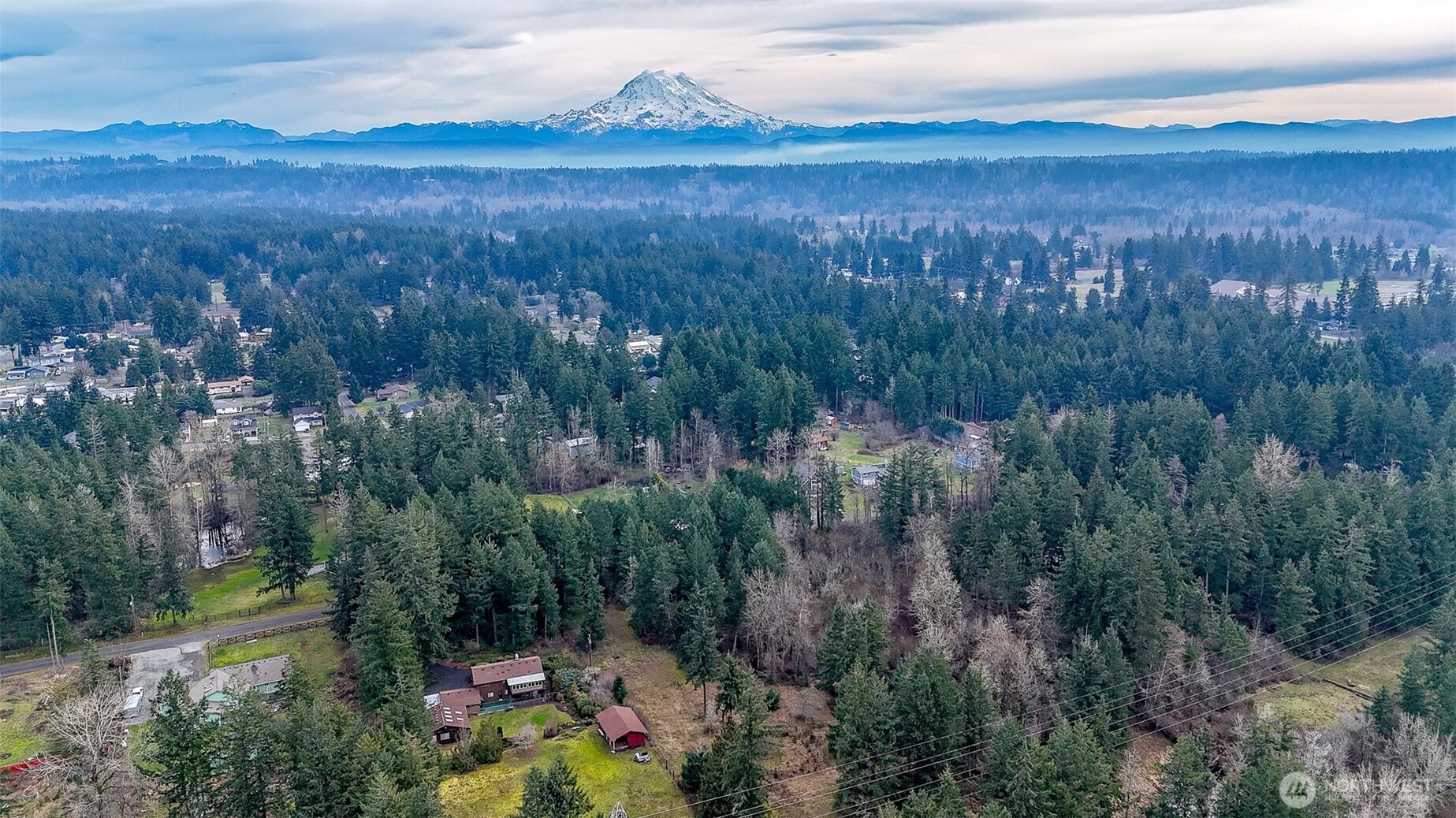 25414 48th Avenue East Graham, WA 98338 - Photo 25 of 25 a view of a lake with mountains in the background