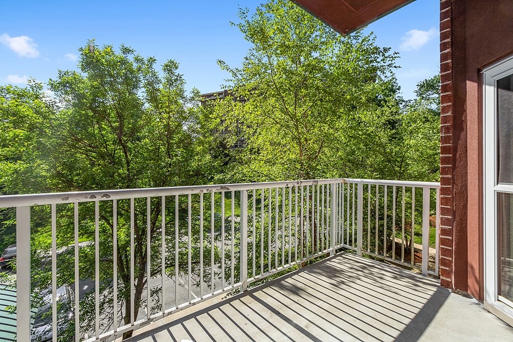 38 Village Road, Unit 310 Middleton, MA 01949 - Photo 3 of 18 a balcony with trees in front of it